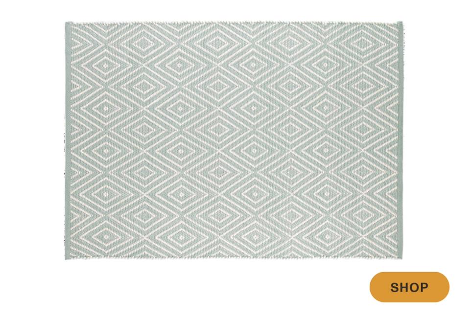 Geometric outdoor rug with diamond trellis pattern in cool sage green and cream