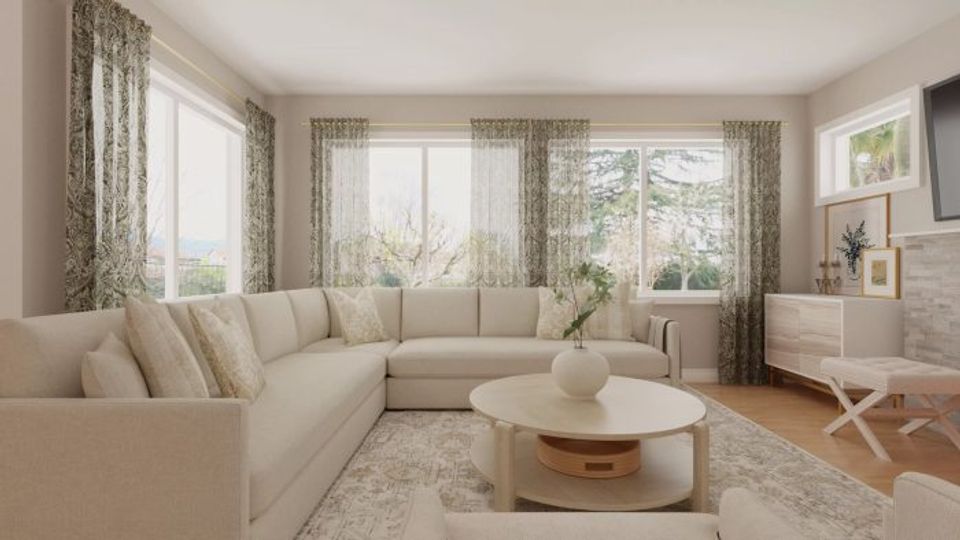 Serene neutral living room with cream sectional, patterned curtains, and soft natural lighting creating a calm, airy coastal-inspired mood