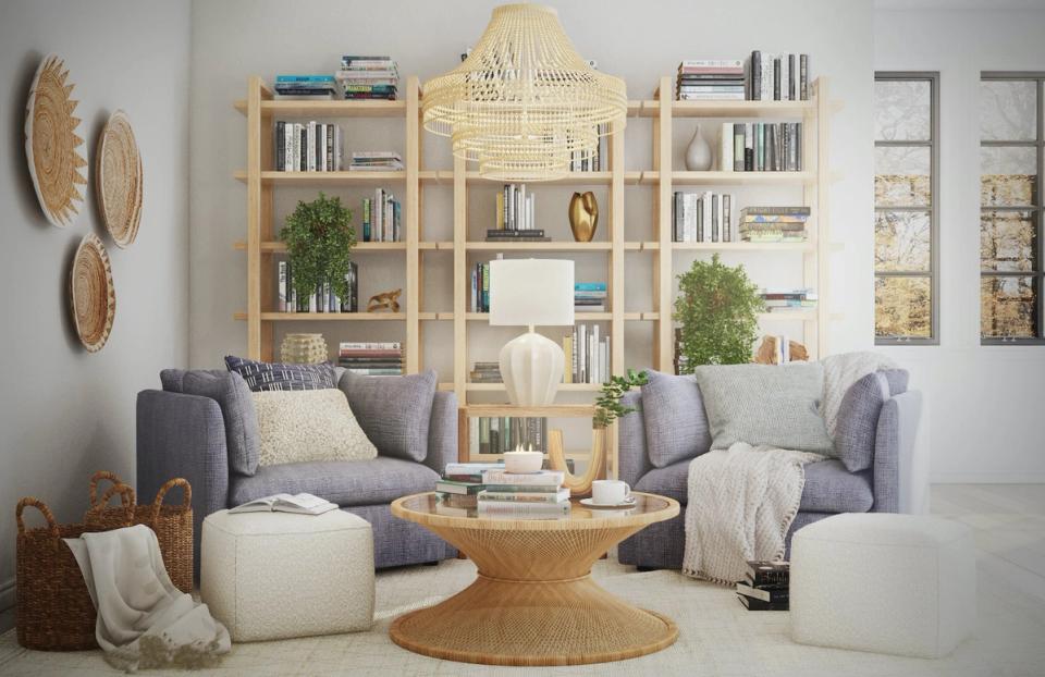 Bright coastal reading nook with natural wood shelving, soft blue armchairs, cream accents, and woven decor elements