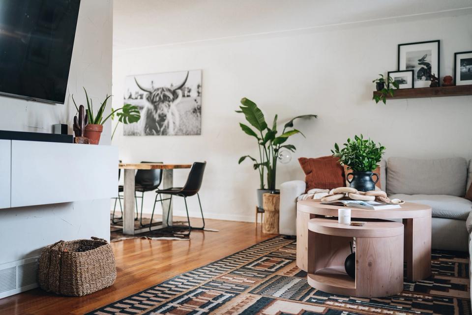 Cohesive open-concept space mixing rustic wood elements, warm neutrals, and botanical styling throughout