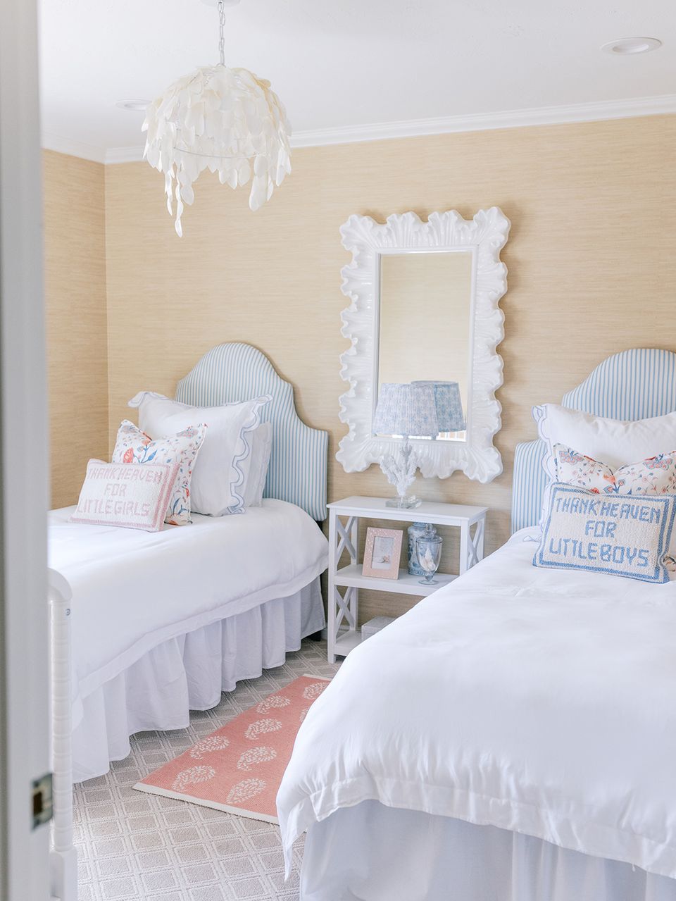Feminine preppy shared bedroom with pale yellow shiplap walls, scalloped blue headboards, draped chandelier, and soft blush and blue tones throughout