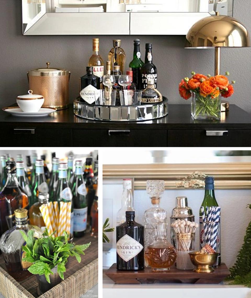 Contemporary bar with slate accent wall, brass fixtures, fresh flowers, and organized glassware display