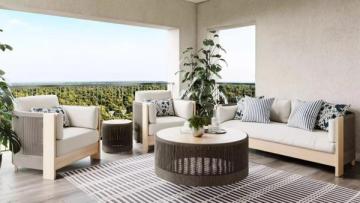Modern patio with neutral upholstered seating, natural wood accents, and geometric patterned rug creating a sophisticated outdoor lounge aesthetic.