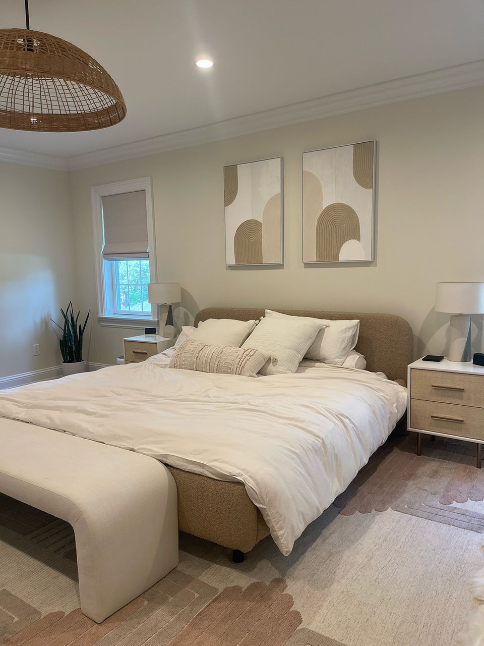 Contemporary boho with soft neutral palette, rattan pendant light, and abstract wall art