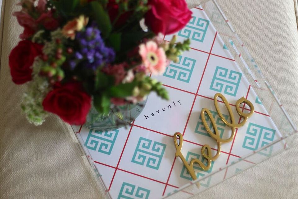 Acrylic tray with geometric blue and pink pattern styled with fresh florals and gold script detailing