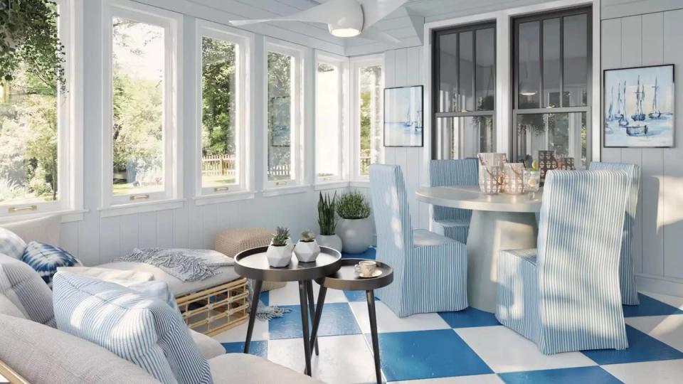 Airy sunroom with white walls, blue geometric patterns, wicker seating, and abundant natural light