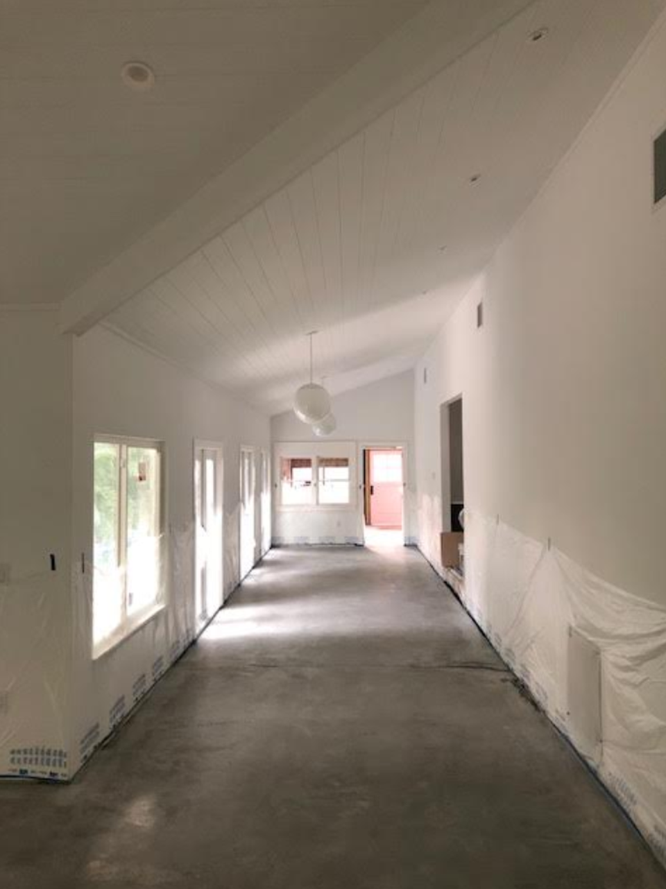 Bright, minimalist construction space with white shiplap and natural light