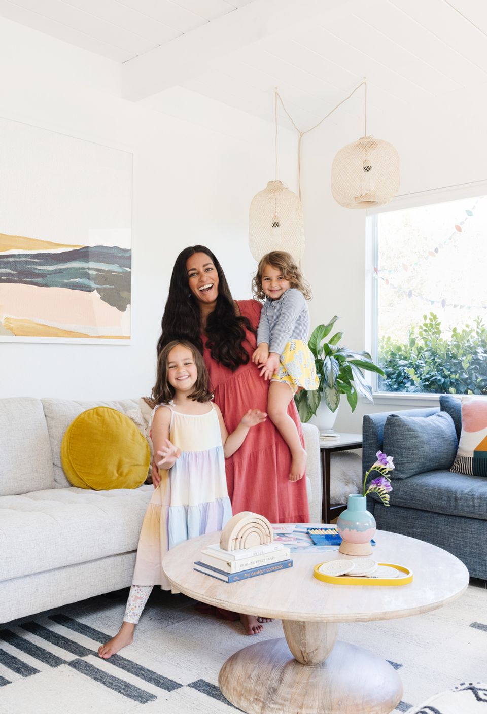 Airy boho interior with warm coral tones, playful yellow accents, and eclectic global artwork