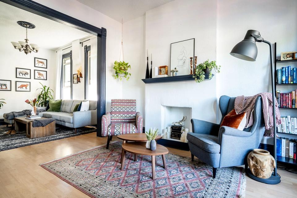 Contemporary fireplace with gray tile accent wall, cream seating, and warm neutral palette