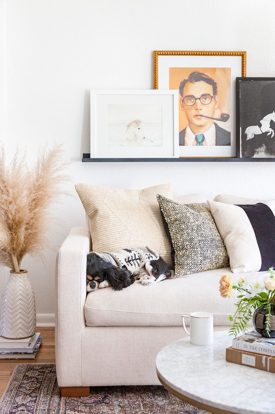 Scandinavian living room in cream and white with pampas grass, gallery wall, and natural textures.