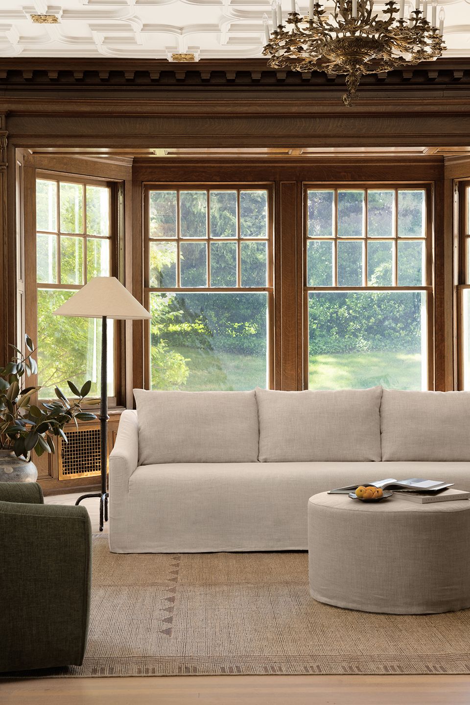 Transitional beige living room with dark wood architectural details, classic furnishings, and soft neutral tones exuding timeless elegance