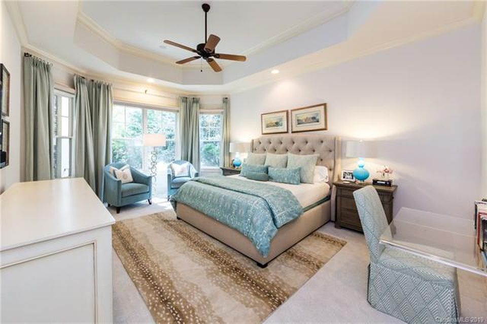 Coastal bedroom with turquoise accents, tufted headboard, and soft neutral tones