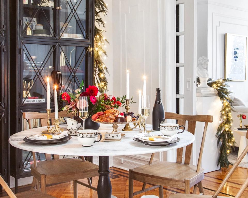 Festive mixed-metal holiday table with deep jewel tones, autumn florals, and warm candlelight