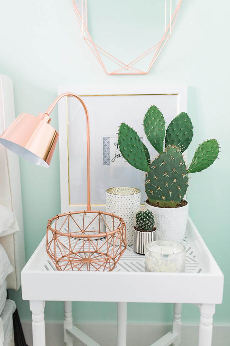 Soft feminine dorm corner with mint walls, rose-gold accents, and potted succulents