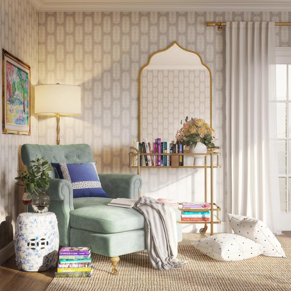 Gentle geometric wallpaper reading nook with soft sage armchair and gold mirror accent