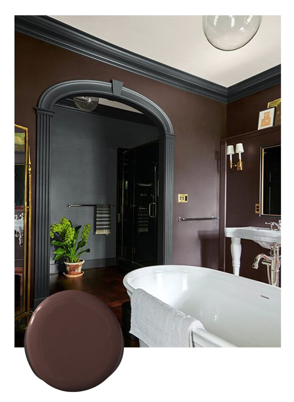 Luxe brown spa-inspired bathroom with sculptural soaker tub, dark archway, and minimalist botanical accents in moody glamour style