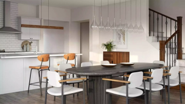 Modern dining space with black table, wood tones, and elegant linear pendant fixtures