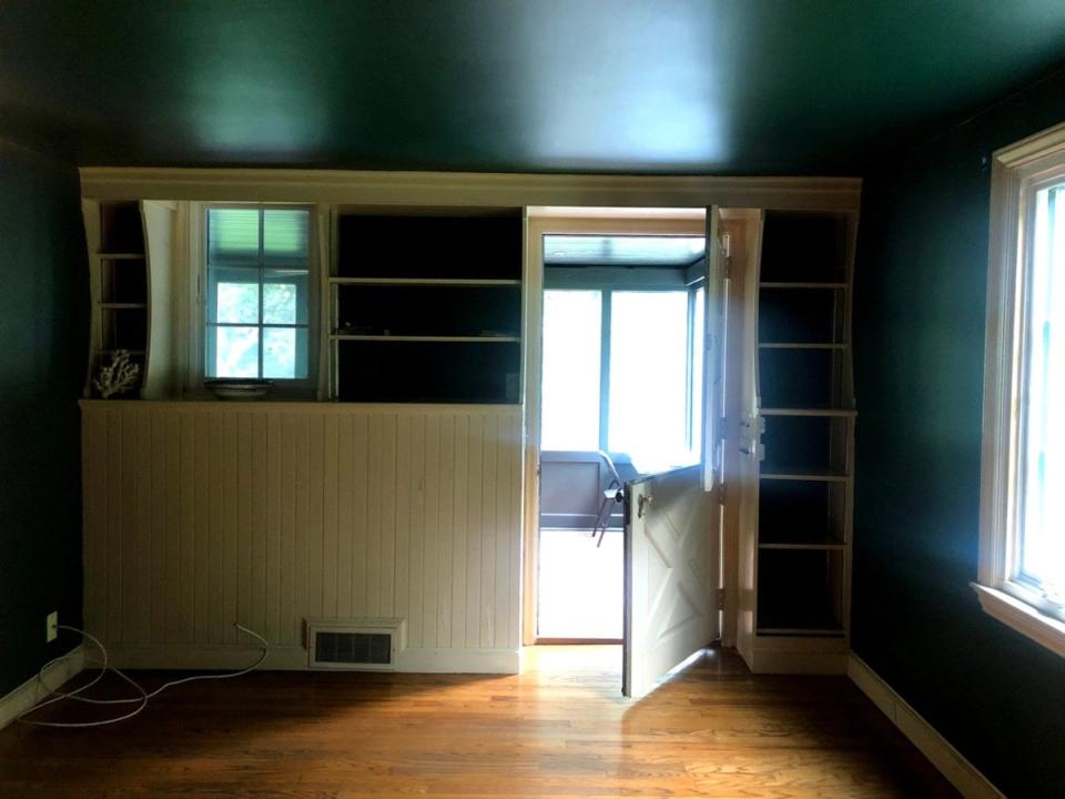 Before: Original dark interior with dated built-in shelving and wood cabinetry