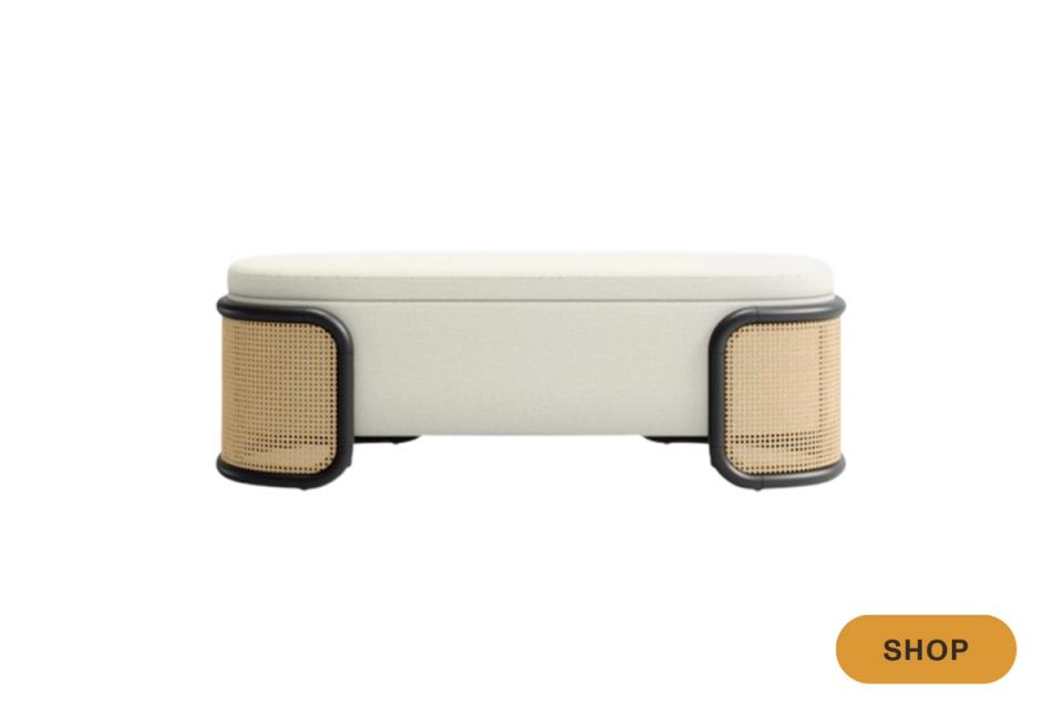 Contemporary cream upholstered bench with woven rattan side panels and black trim