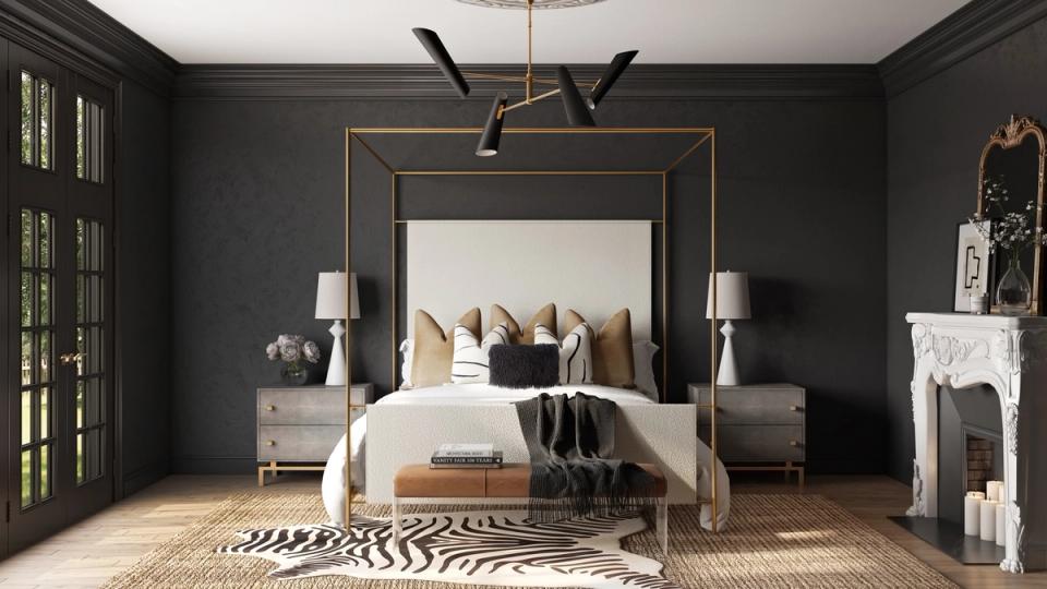 Luxe dark bedroom with black walls, brass-framed mirror, and safari-inspired natural textures