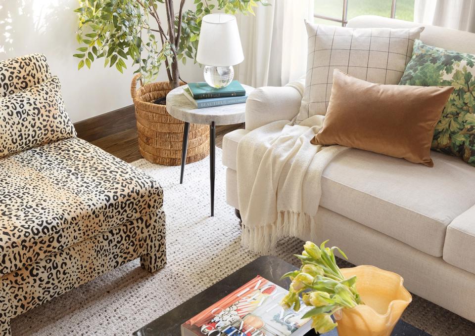 Eclectic living room blending leopard print chair, warm neutrals, and organic textures