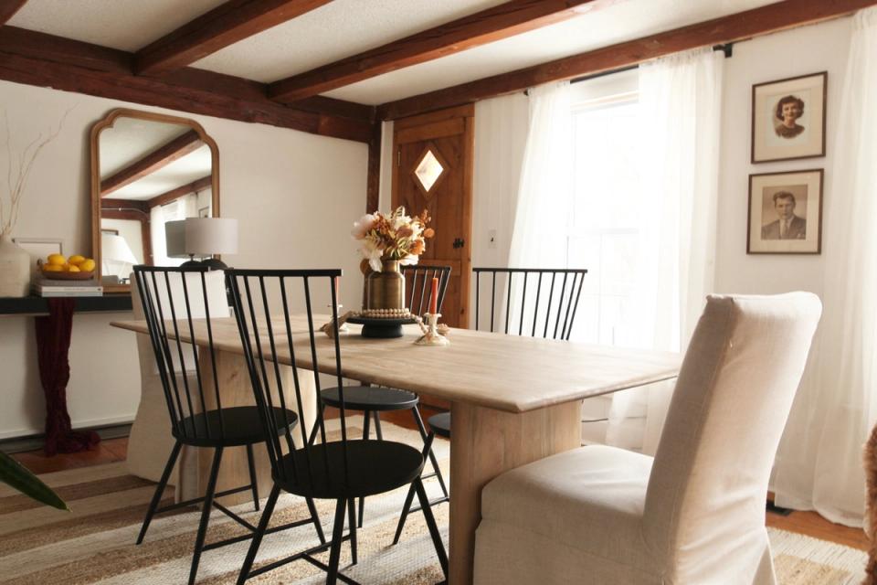 Eclectic dining room combining dark Windsor chairs, light wood table, and vintage-inspired décor