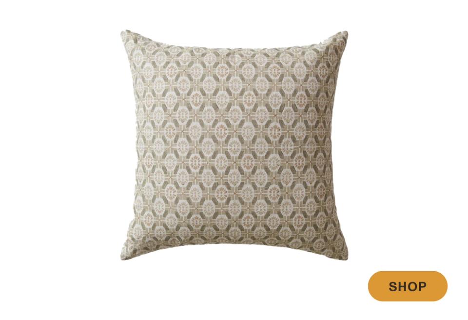 Beige throw pillow with subtle all-over geometric diamond trellis pattern