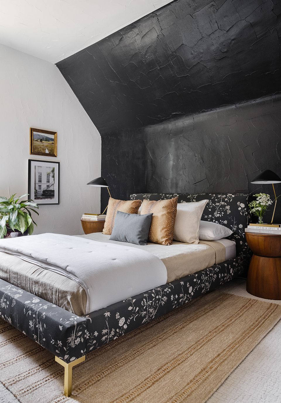Contemporary bedroom with dramatic black architectural headboard and warm wood accents