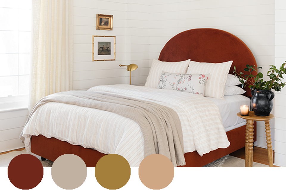 Serene bedroom with burgundy headboard, cream linens, and warm neutral palette.