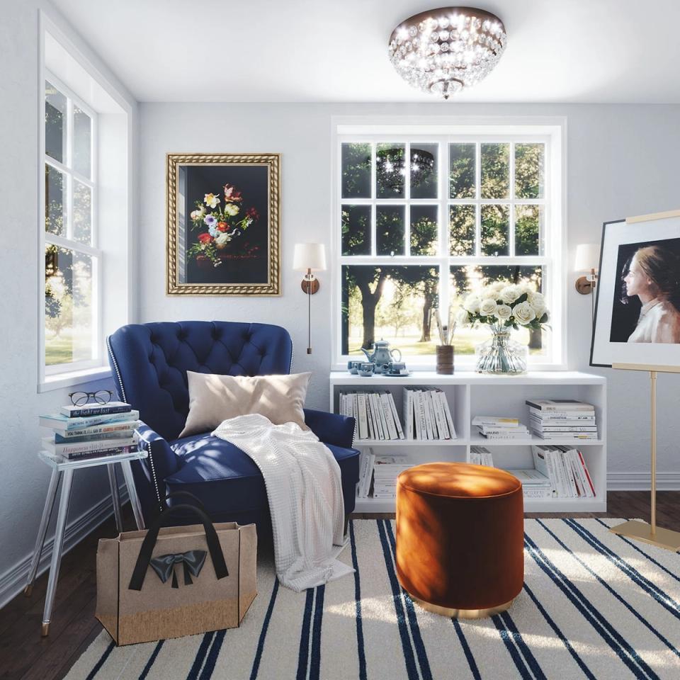 Bright reading nook with navy chair, striped rug, and classic coastal-inspired design