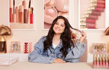 Minimalist beauty desk with soft pink and beige tones, organized cosmetics display