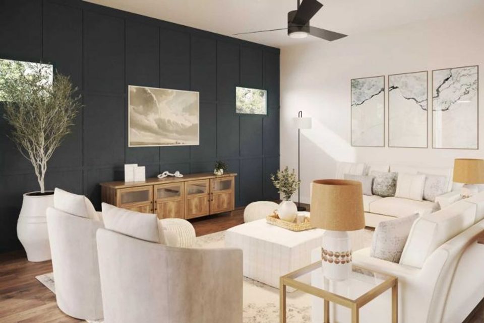 Modern living room with dark navy accent wall, white seating, and warm wood storage