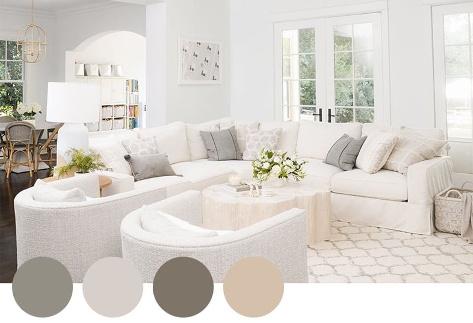 Soft contemporary living room in neutral grays, creams, and beiges with curved seating and airy minimalist aesthetic