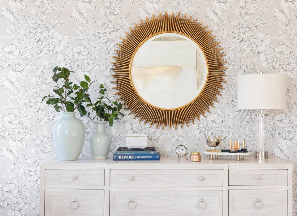 Soft minimalist dresser with gold sunburst mirror and mixed metal accents