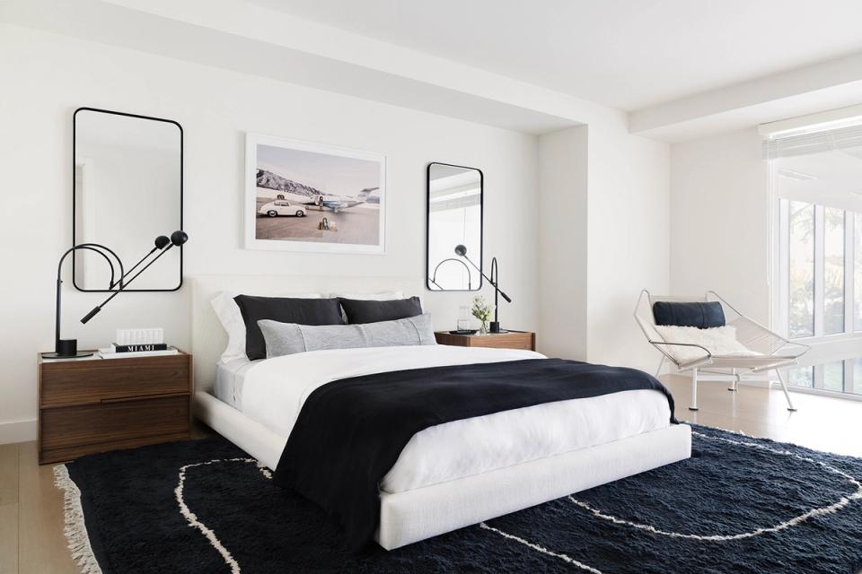 Mid-century modern bedroom with walnut wood, black and white contrast, and geometric wall art