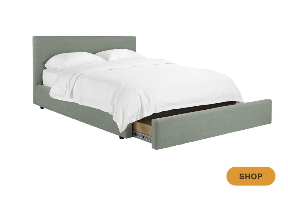 Contemporary sage green upholstered storage bed with open drawer and modern silhouette