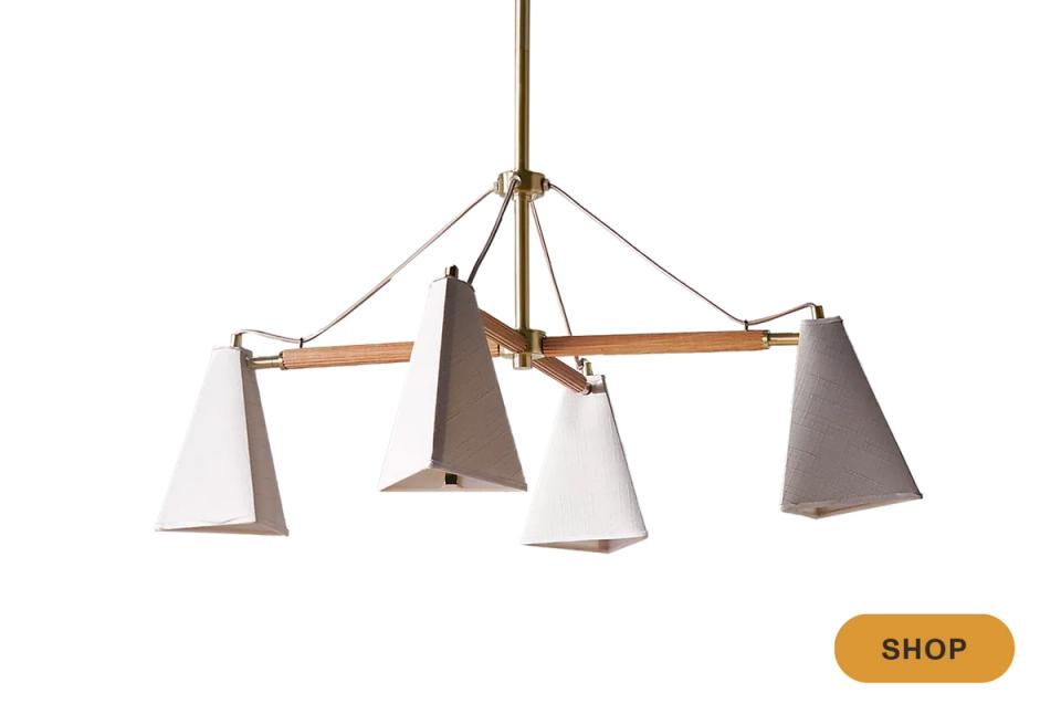 Eclectic chandelier with mixed materials: brass frame, wood accents, and linen shades