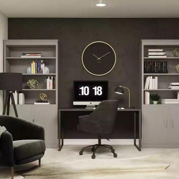 Minimalist home office with dark charcoal wall, white shelving, brass clock, and sleek furniture creating serene, focused work environment