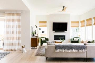 Contemporary coastal interior with warm wood, cream tones, and soft natural light throughout
