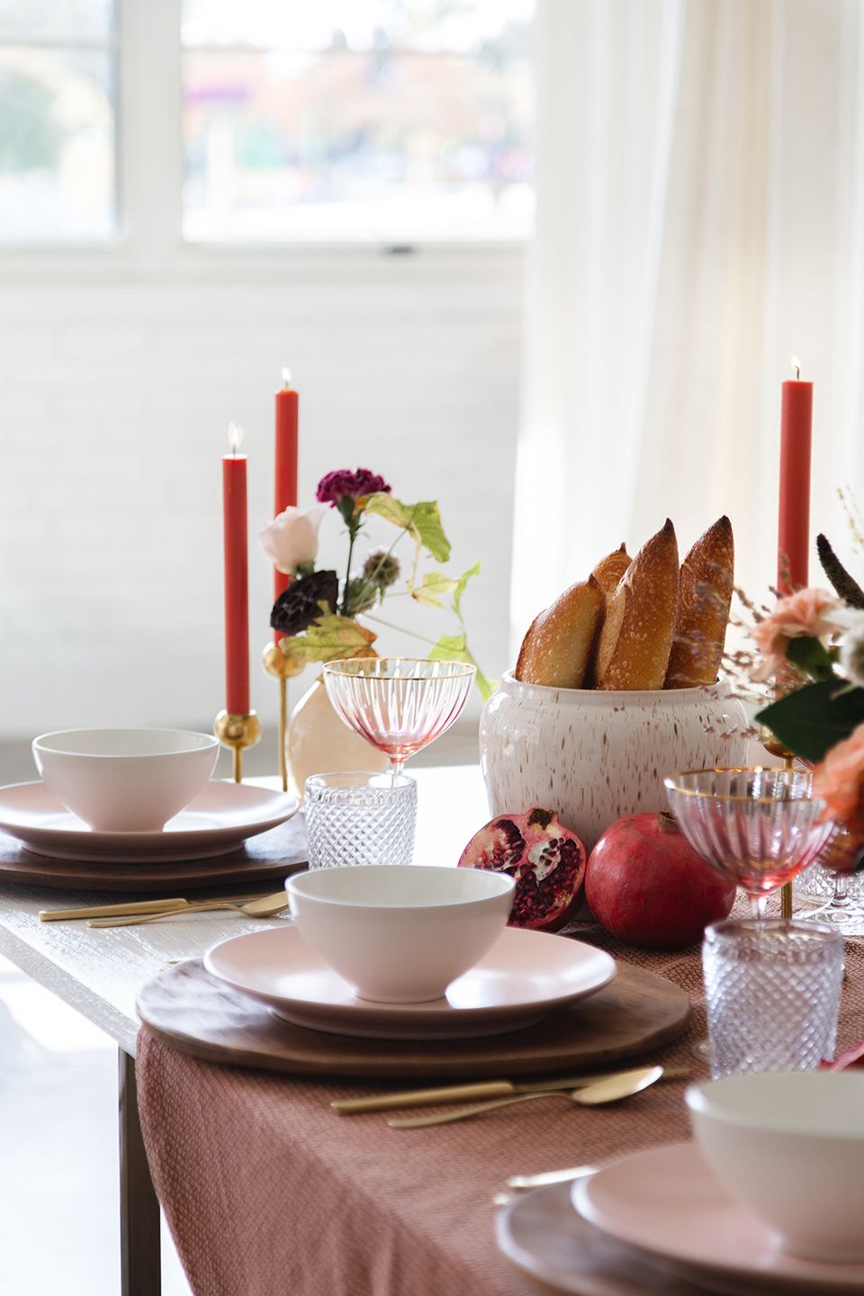Contemporary red and white tablescape with burgundy florals, berry tones, and geometric glass accents