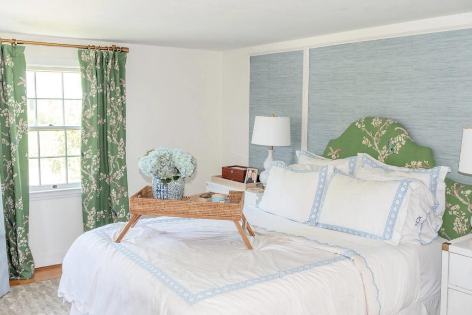 Serene transitional bedroom with blue-green shiplap accent wall and soft green botanical curtains