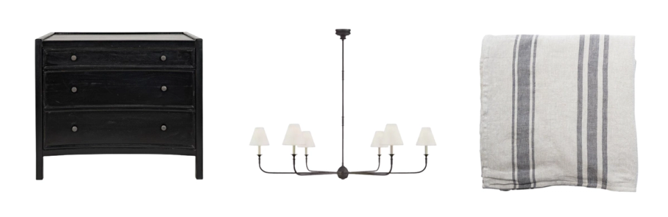 Coastal style furnishings: black dresser, metal chandelier, and blue striped linen textiles