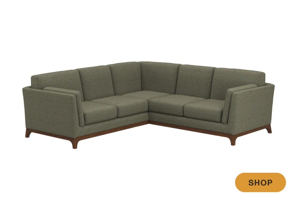 Mid-century sage green sectional with tapered wooden legs and refined proportions