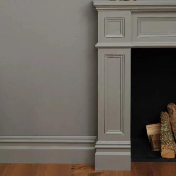 Contemporary fireplace surround with soft sage-gray walls and pale trim molding in understated modern style