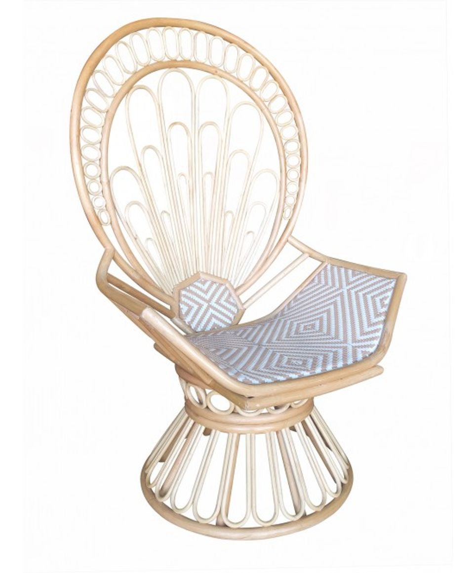 Light wood rattan peacock chair with geometric seat cushion and sculptural fan backrest