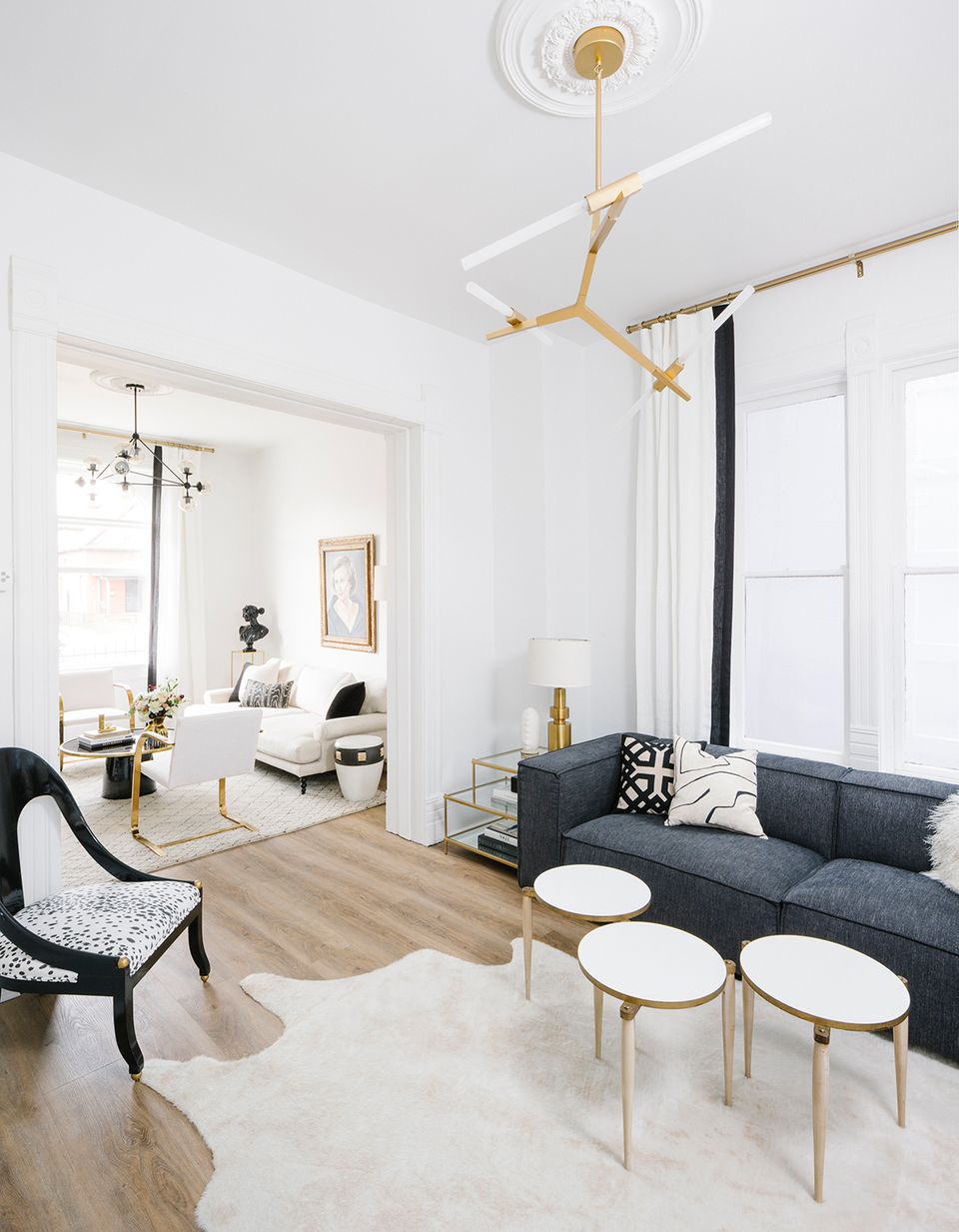 Scandinavian-inspired minimalist living room with navy sofa, natural wood accents, cream runner