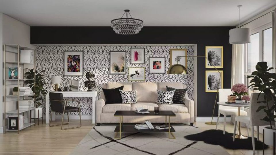 Contemporary living room with dramatic black accent wall, cream sofa, gallery wall, and black geometric rug creating sophisticated contrast
