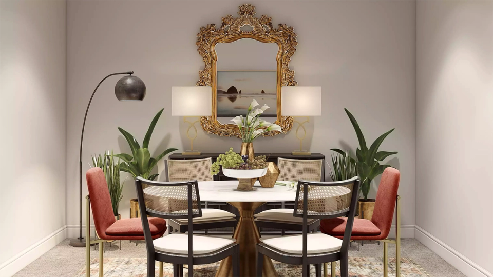 Eclectic dining room with coral velvet chairs, ornate gold mirror, and moody botanical-inspired aesthetic