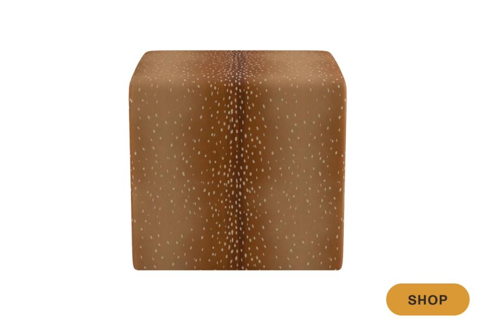 Contemporary bronze ottoman with textured dot pattern and compact cube silhouette