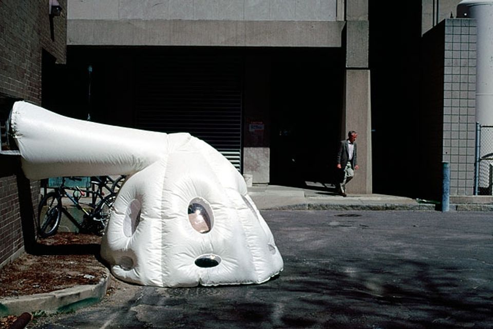 Contemporary white inflatable pod shelter with sculptural form and circular openings
